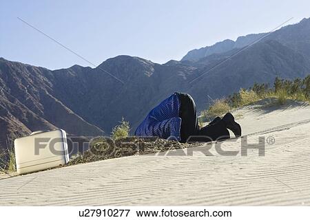 Stock Photo - Businessman Burying Head in the Sand. Fotosearch