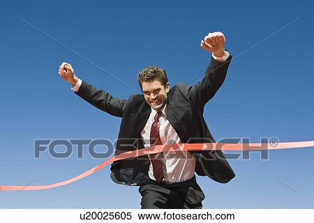 Stock Photography - Businessman Crossing the Winning Line. Fotosearch