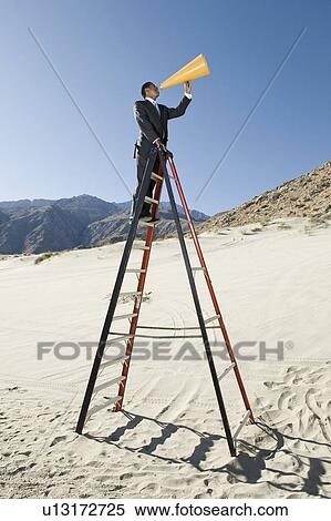 Businessman on Stepladder Using Megaphone in Desert View Large Photo Image Stock Photography - Businessman on Stepladder Using Megaphone in Desert. Fotosearch