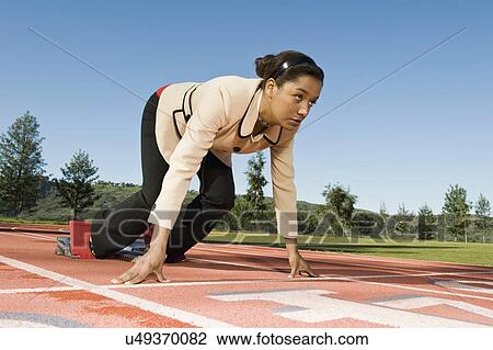 Stock Image - Businesswoman At Starting Blocks. Fotosearch