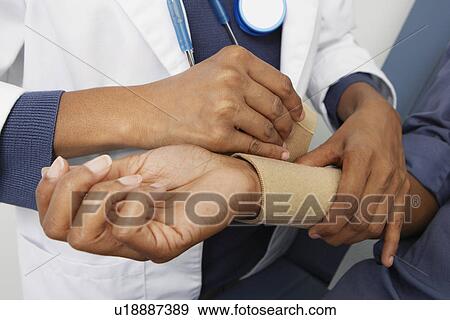 Stock Photo - Checking pateint's blood pressure. Fotosearch