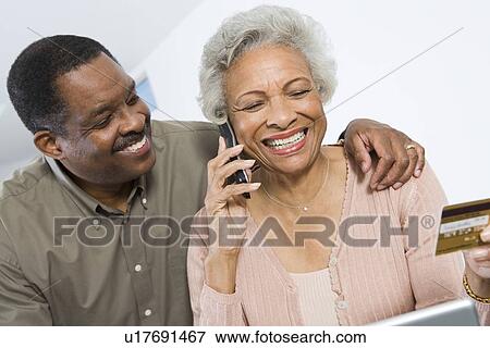 Stock Photo - Cheerful Senior Couple Managing Home Finances. Fotosearch
