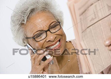Stock Image - Cheerful Senior Woman Studying Stocks and Shares. Fotosearch