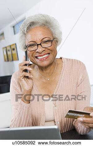 Cheerful Senior Woman Using Laptop, Holding Credit Card View Large Photo Image Stock Image - Cheerful Senior Woman Using Laptop, Holding Credit Card. Fotosearch