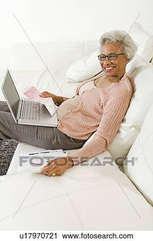 Stock Image - Cheerful Senior Woman Using Laptop. Fotosearch