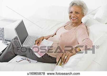 Stock Photo - Cheerful Senior Woman Using Laptop. Fotosearch