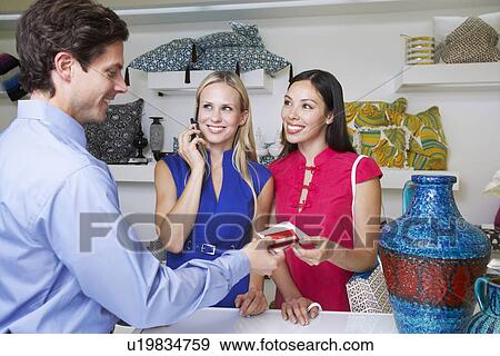 Stock Photo - Clerk Handing Receipt to Customer. Fotosearch