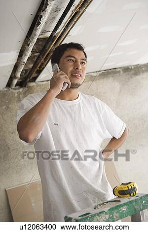 Construction worker using mobile phone View Large Photo Image Stock Image - Construction worker using mobile phone. Fotosearch