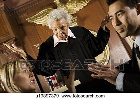 Stock Photo - Couple arguing in front of judge in court. Fotosearch