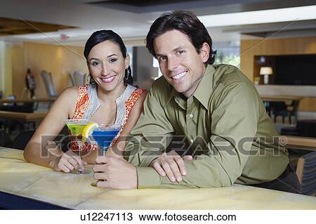 Stock Image - Couple Drinking Martinis. Fotosearch