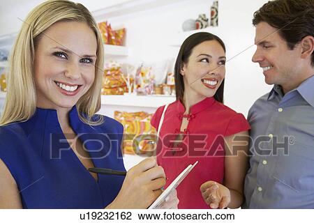 Stock Image - Couple Making a Purchase. Fotosearch