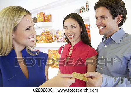 Stock Image - Couple Making a Purchase. Fotosearch