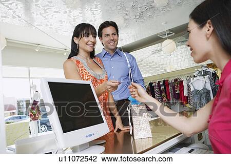 Couple Paying for Merchandise View Large Photo Image Stock Image - Couple Paying for Merchandise. Fotosearch