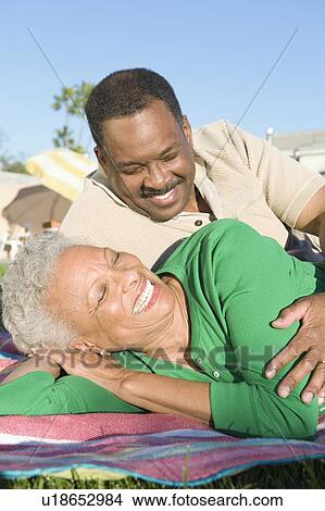 Picture - Couple reclining on grass. Fotosearch