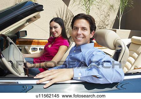 Stock Photography - Couple Sitting in a Convertible. Fotosearch