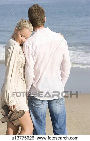 Couple walking on beach View Large Photo Image Stock Photograph - Couple walking on beach. Fotosearch