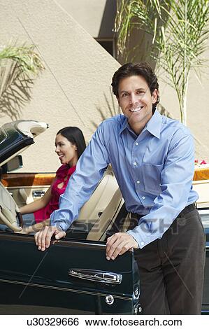 Couple with a Convertible View Large Photo Image Stock Photograph - Couple with a Convertible. Fotosearch