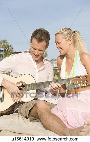 Stock Photo - Couple with guitar. Fotosearch