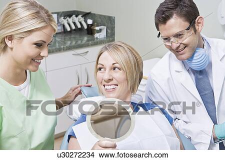 Dentist and patient using mirror View Large Photo Image Picture - Dentist and patient using mirror. Fotosearch