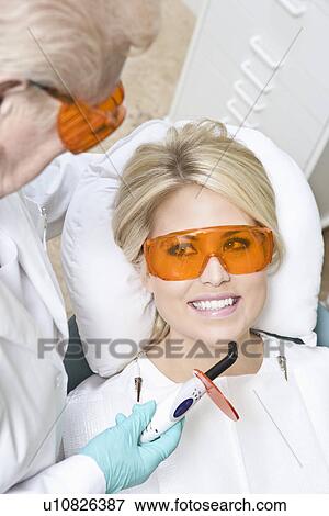 Dentist inspecting patient's teeth View Large Photo Image Stock Photo - Dentist inspecting patient's teeth. Fotosearch