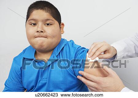 Stock Image - Disinfecting boy' sarm. Fotosearch