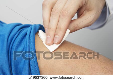 Stock Image - Disinfecting patient's arm. Fotosearch