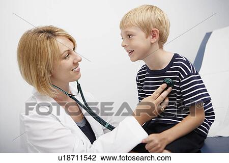 Doctor examining boy View Large Photo Image Stock Image - Doctor examining boy. Fotosearch