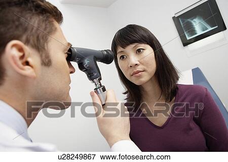 Doctor examining female patient in hospital View Large Photo Image Stock Photo - Doctor examining female patient in hospital. Fotosearch