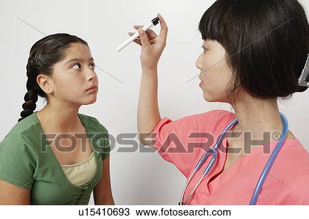 Stock Image - Doctor examining girl in hospital. Fotosearch