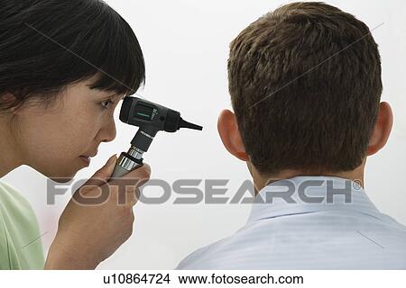 Doctor examining male patient in hospital View Large Photo Image Picture - Doctor examining male patient in hospital. Fotosearch