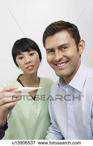 Doctor examining male patient in hospital View Large Photo Image Stock Photo - Doctor examining male patient in hospital. Fotosearch