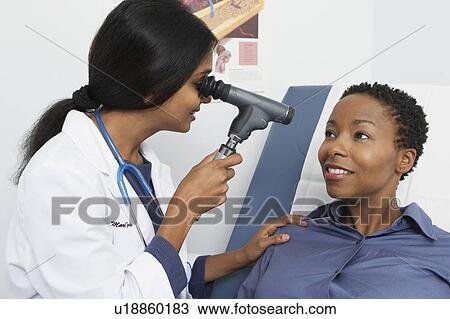 Doctor examining patient in hospital View Large Photo Image Stock Image - Doctor examining patient in hospital. Fotosearch