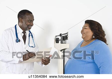 Picture - Doctor examining patient. Fotosearch