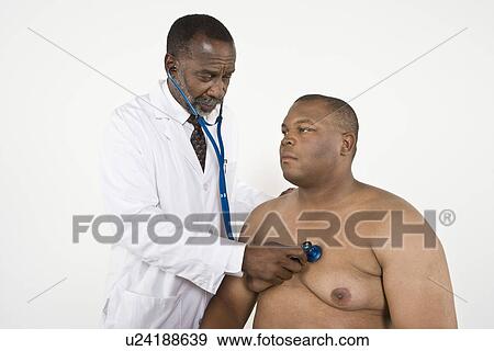 Doctor examining patient View Large Photo Image Stock Photo - Doctor examining patient. Fotosearch