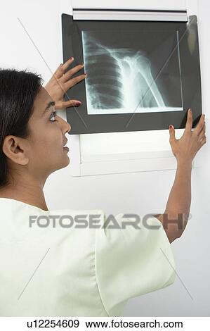 Doctor examining x-ray in hospital View Large Photo Image Stock Photo - Doctor examining x-ray in hospital. Fotosearch