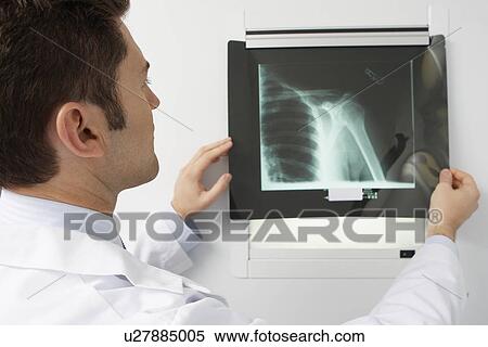 Doctor examining x-ray in hospital View Large Photo Image Stock Photography - Doctor examining x-ray in hospital. Fotosearch