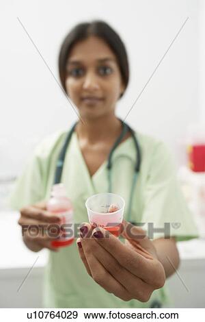Doctor giving medicine View Large Photo Image Stock Photo - Doctor giving medicine. Fotosearch