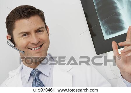 Doctor holding x-ray in hospital, portrait View Large Photo Image Stock Image - Doctor holding x-ray in hospital, portrait. Fotosearch