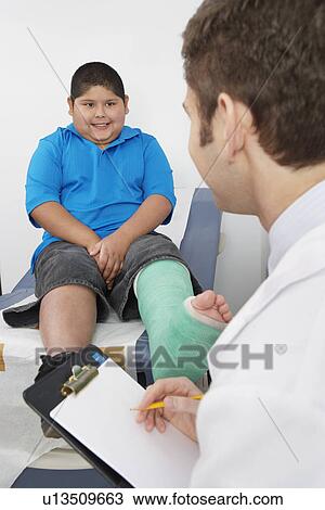 Doctor interviewing boy-patient View Large Photo Image Stock Image - Doctor interviewing boy-patient. Fotosearch
