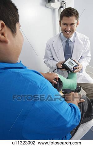 Doctor preparing to check boy's blood pressure View Large Photo Image Stock Image - Doctor preparing to check boy's blood pressure. Fotosearch
