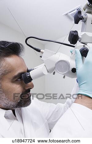 Doctor using microscope View Large Photo Image Picture - Doctor using microscope. Fotosearch
