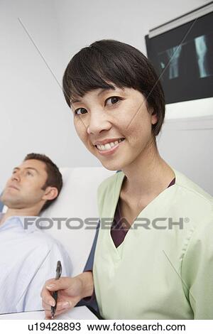 Doctor with male patient in hospital View Large Photo Image Stock Image - Doctor with male patient in hospital. Fotosearch