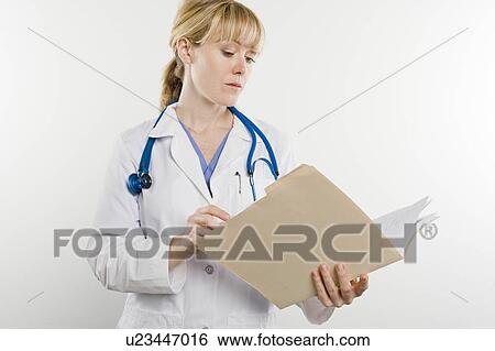 Doctor with medical file View Large Photo Image Stock Photograph - Doctor with medical file. Fotosearch