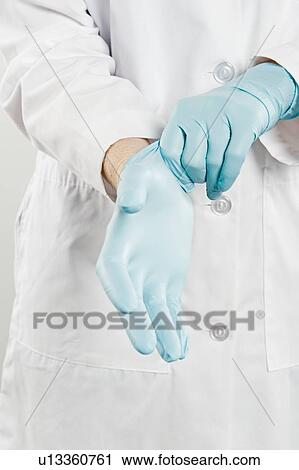 Doctor with rubber gloves, mid section View Large Photo Image Stock Image - Doctor with rubber gloves, mid section. Fotosearch