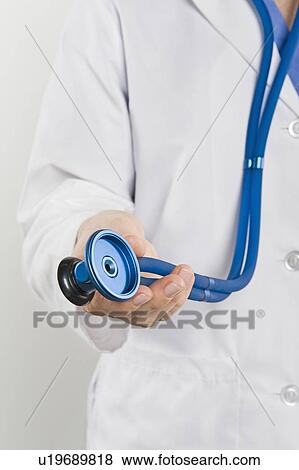 Stock Photo - Doctor with stethoscope, mid section. Fotosearch
