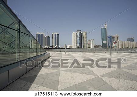 Stock Image - Dubai, UAE, Architectural detail of Emirates Towers plaza and surrounding buildings. Fotosearch