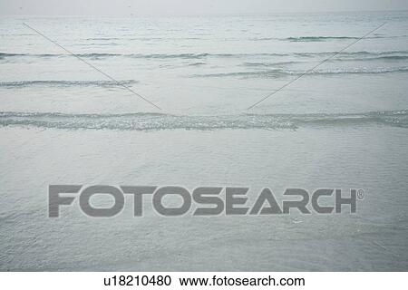 Dubai, UAE, Tiny ripples in Arabian Gulf at sunset on public beach in Jumeirah View Large Photo Image Stock Image - Dubai, UAE, Tiny ripples in Arabian Gulf at sunset on public beach in Jumeirah. Fotosearch