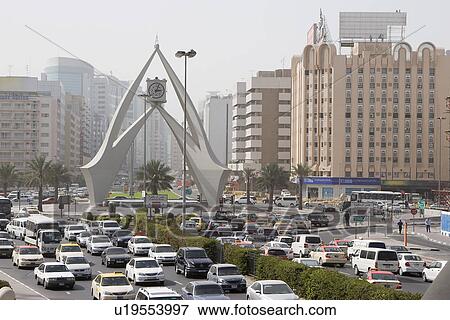 Dubai, UAE, Traffic is backed up in all directions at the Clock Tower roundabout on Al-Maktoum Road. View Large Photo Image Stock Photo - Dubai, UAE, Traffic is backed up in all directions at the Clock Tower roundabout on Al-Maktoum Road.. Fotosearch