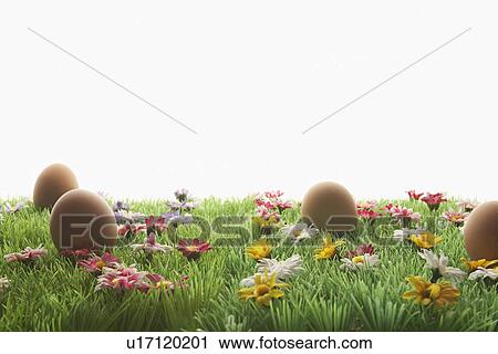 Stock Image - Easter eggs on artificial meadow. Fotosearch