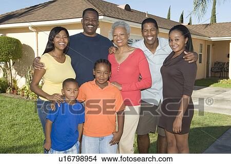 Picture - Family outside house, portrait. Fotosearch